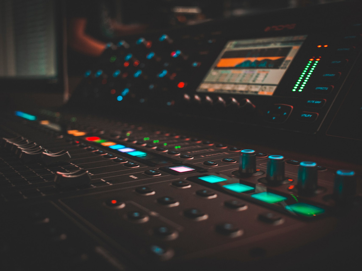 Multiple buttons, dials and sliders on a control console