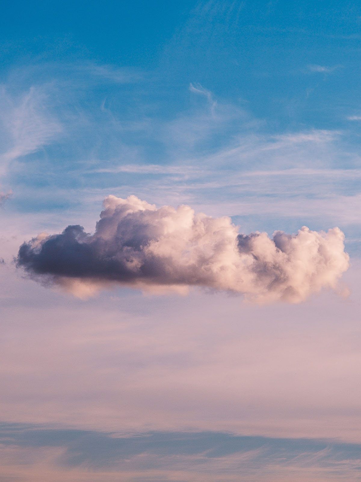 Fluffy white cloud in a purple blue sky.