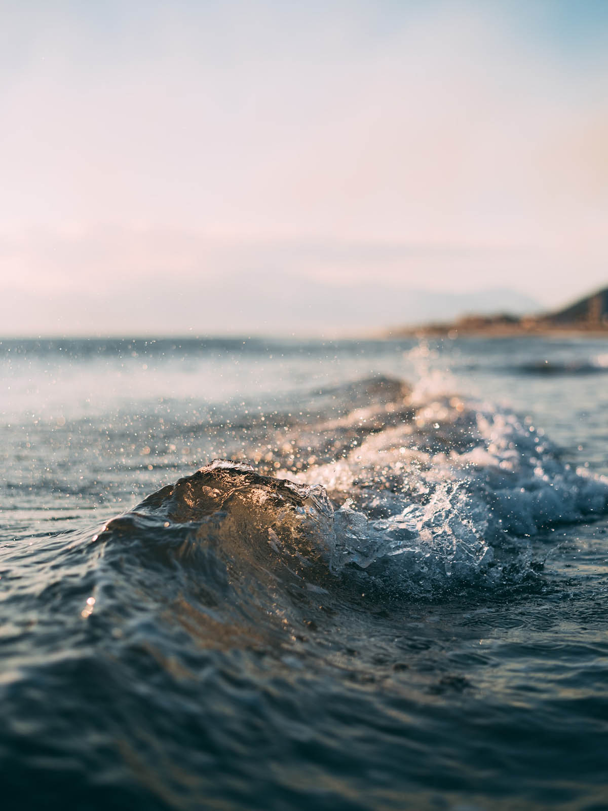 The crest of a small wave as it splashes over.