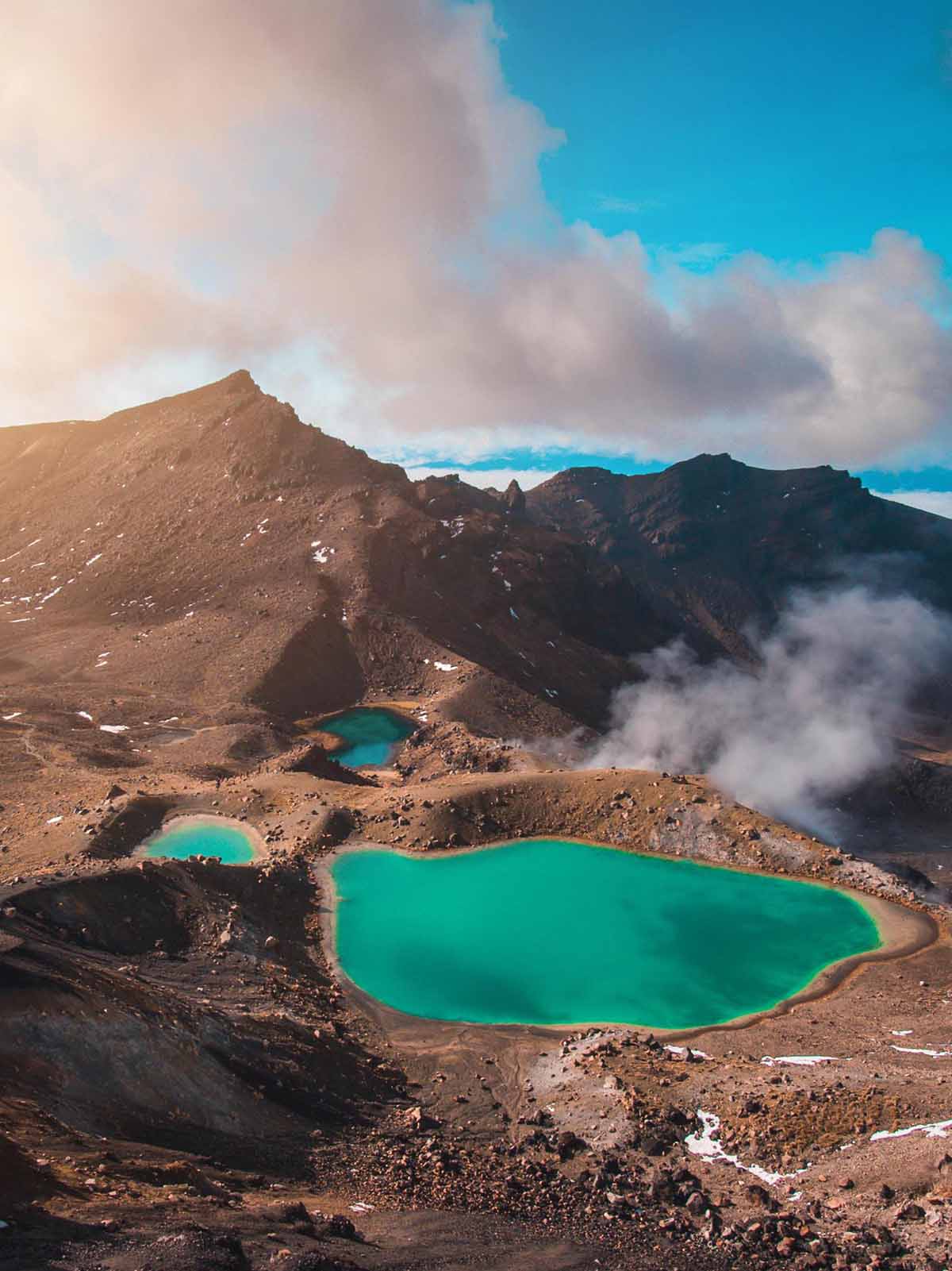 Aqua blue pools in valley between rocky peaks.